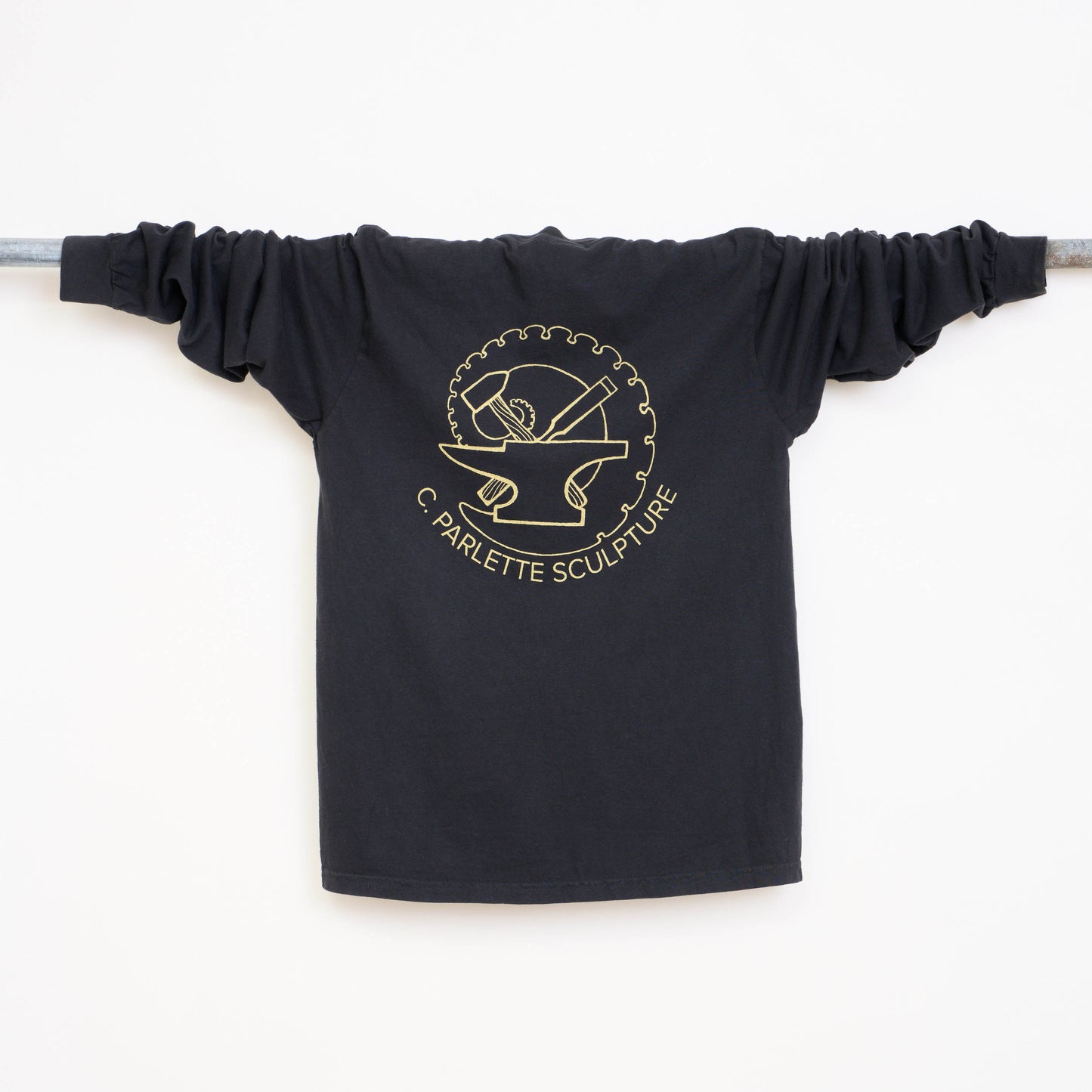 Back view of a black t-shirt with gold logo and text on a white background.