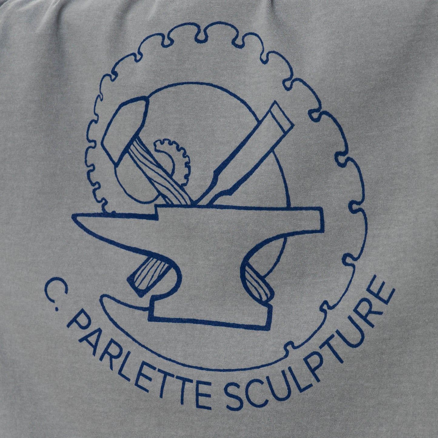 Close-up view of back logo of grey t-shirt.
