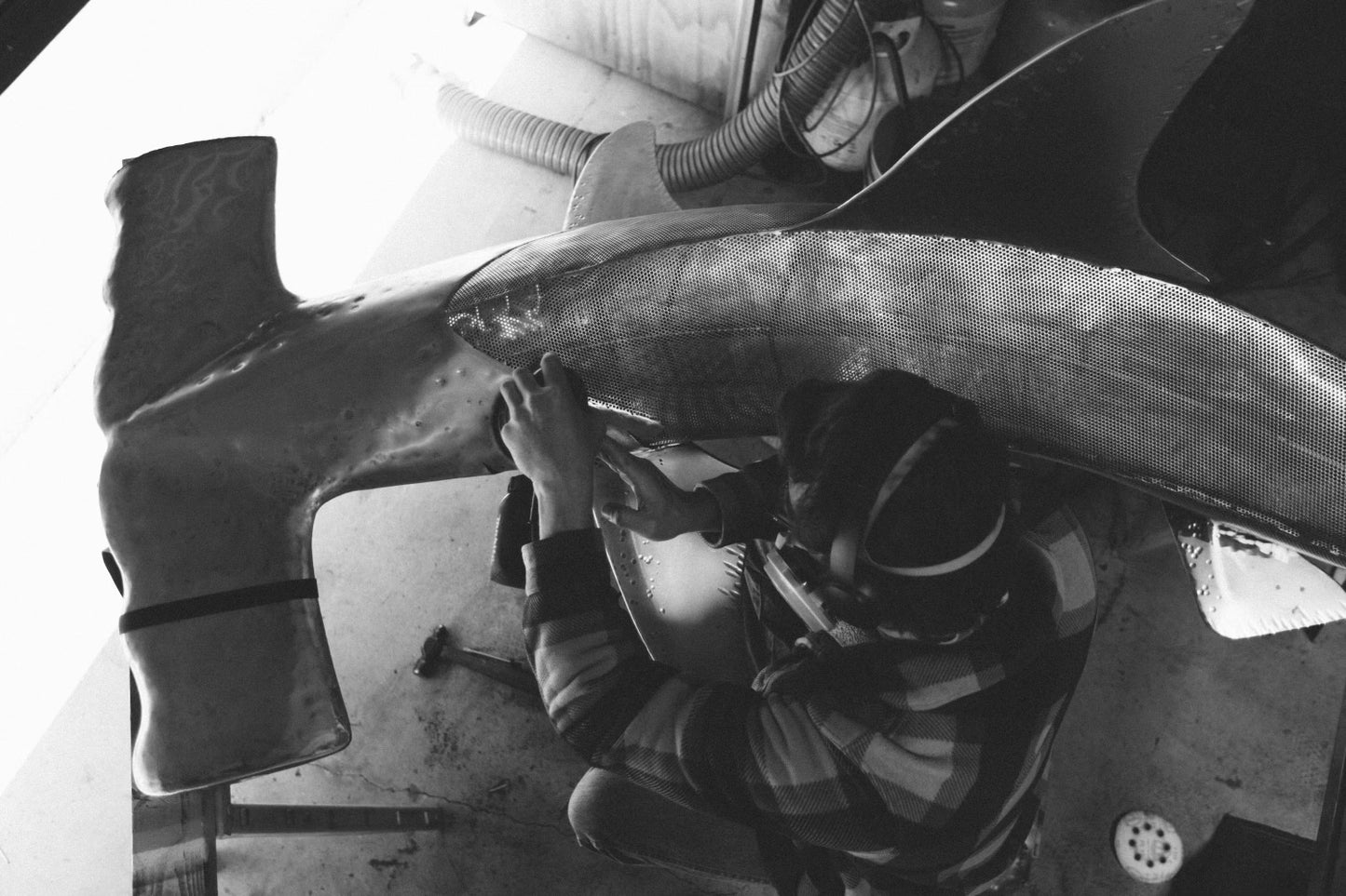 Overhead view of Casey Parlette working on a hammerhead shark sculpture.