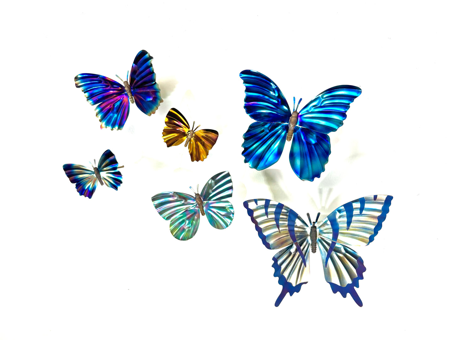 Different butterfly sculptures in a variety of sizes with the blue morpho and swallowtail the largest and the gold butterfly being the smallest.