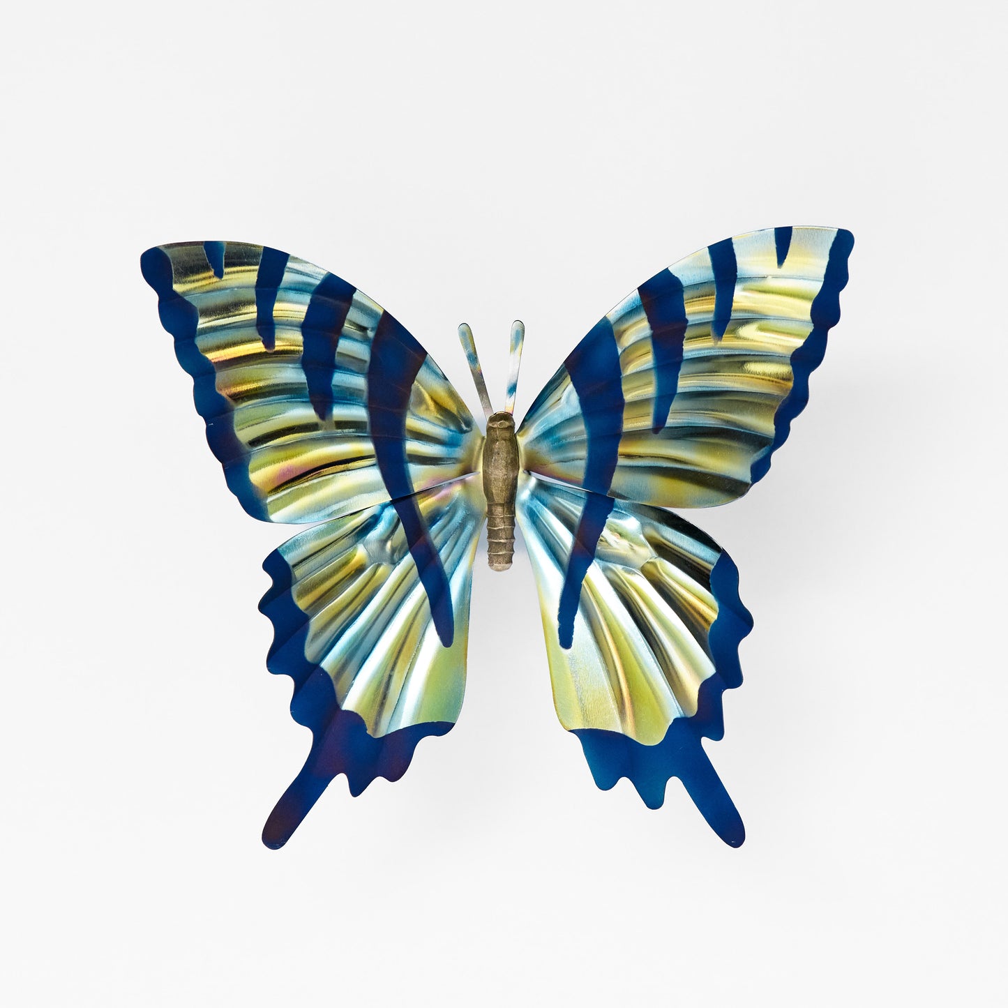 Front view of a large butterfly sculpture with iridescent silver wings and dark blue stripes to look like a tiger swallowtail butterfly.
